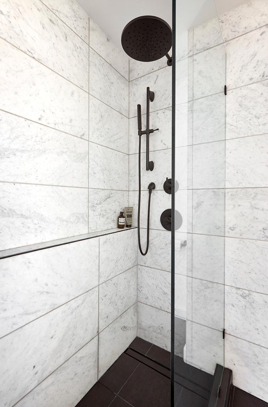 White Shower Black Appliances and Veining