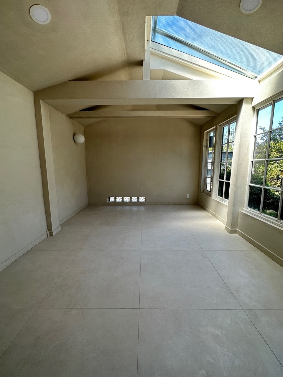 Remodeled detached garage with new concrete floors, drywall, paint, and skylight