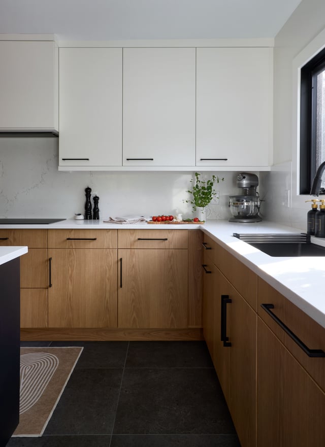 Modern kitchen with two-tone wood and white cabinetry.