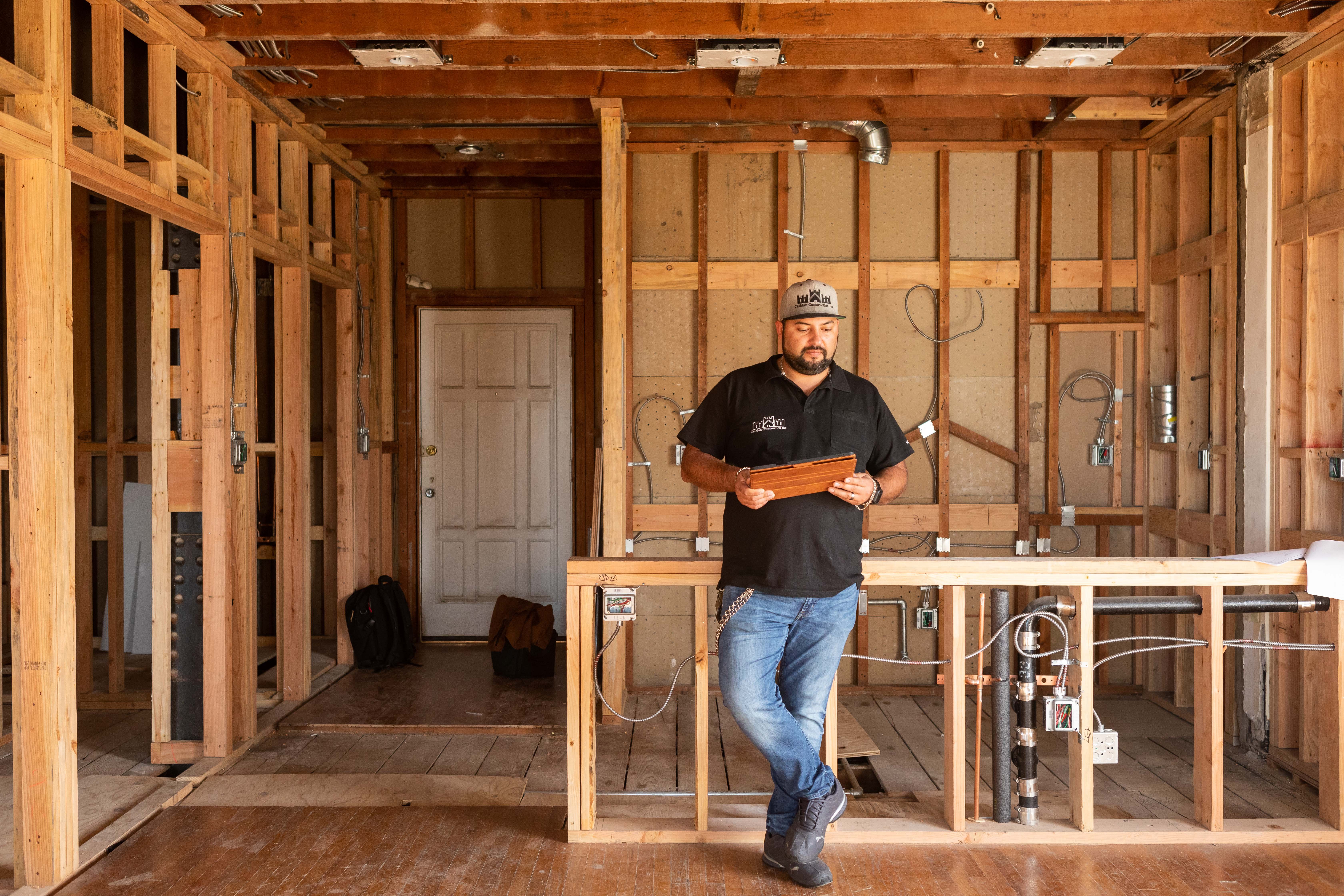 Gut renovation of a home with the walls stripped down to the studs exposing electrical and plumbing systems