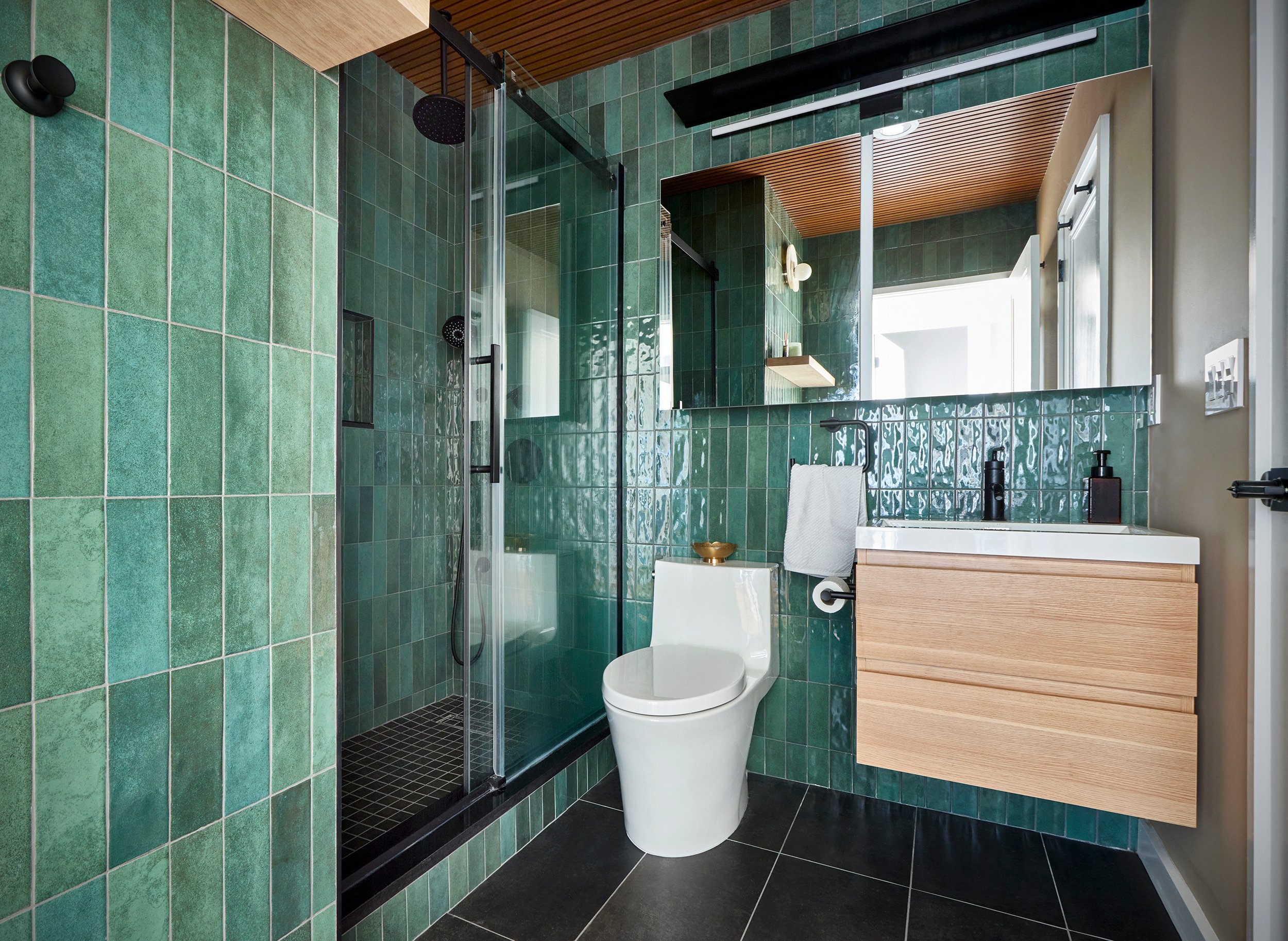 bathroom with modern tile and wooden cabinets