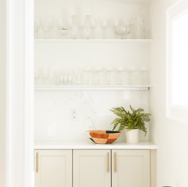 Open shelving and cabinets in a white kitchen