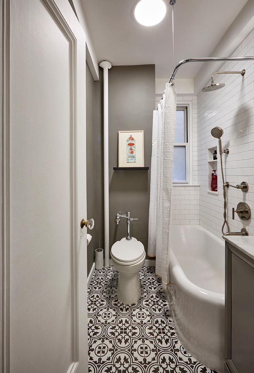 Small bathroom with bold floor and window in shower