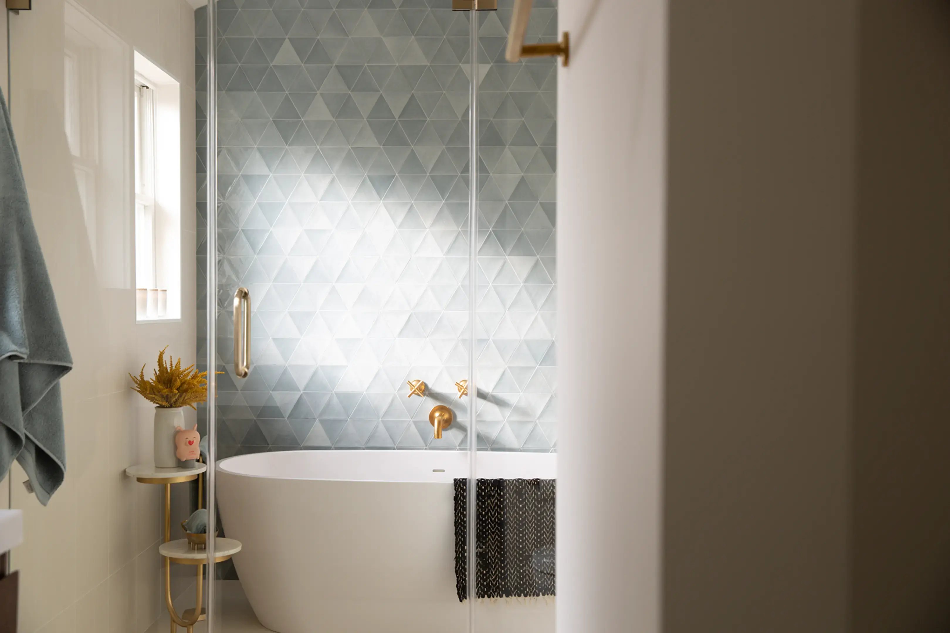 Free standing tub behind glass