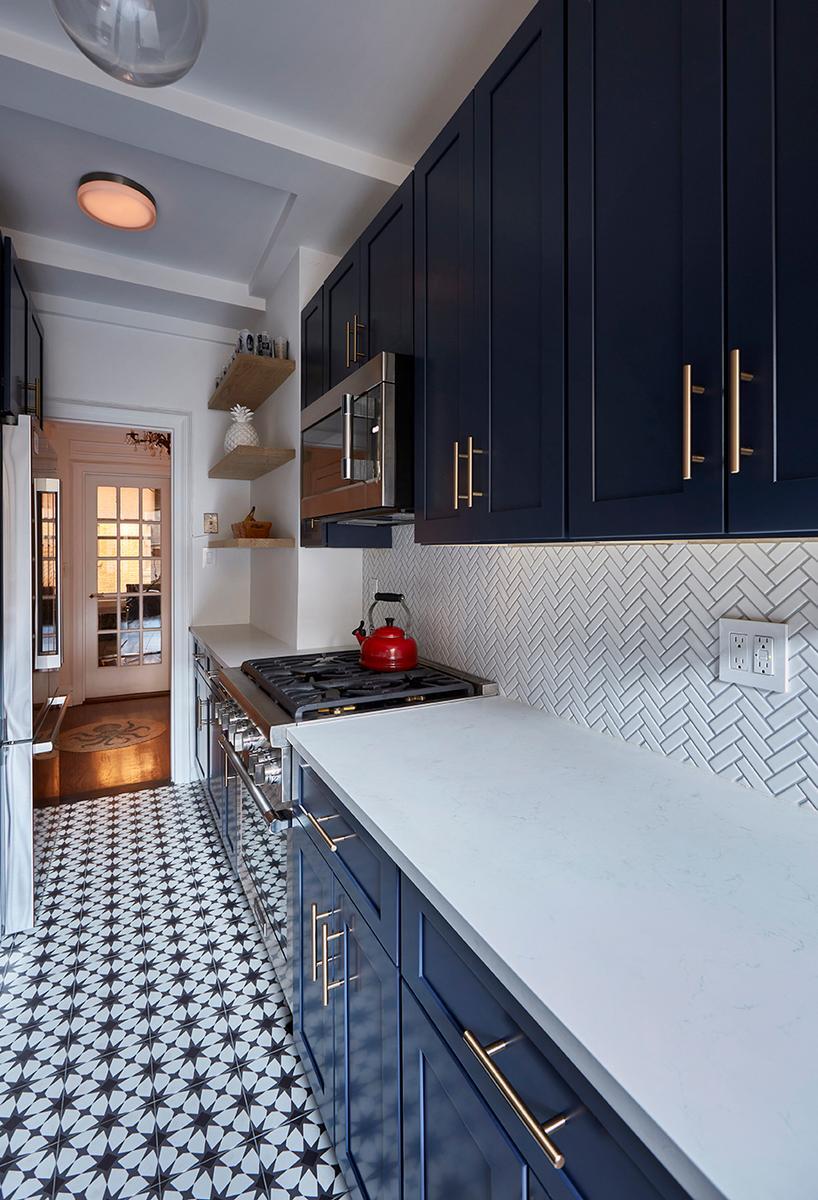 Kitchen With Eye-Catching Tiles and Blue Cabinets in New York