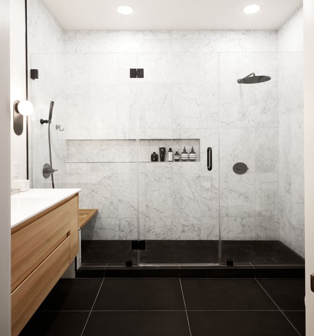 Bathroom with black and white tiles, a walk-in closet, and wood vanity