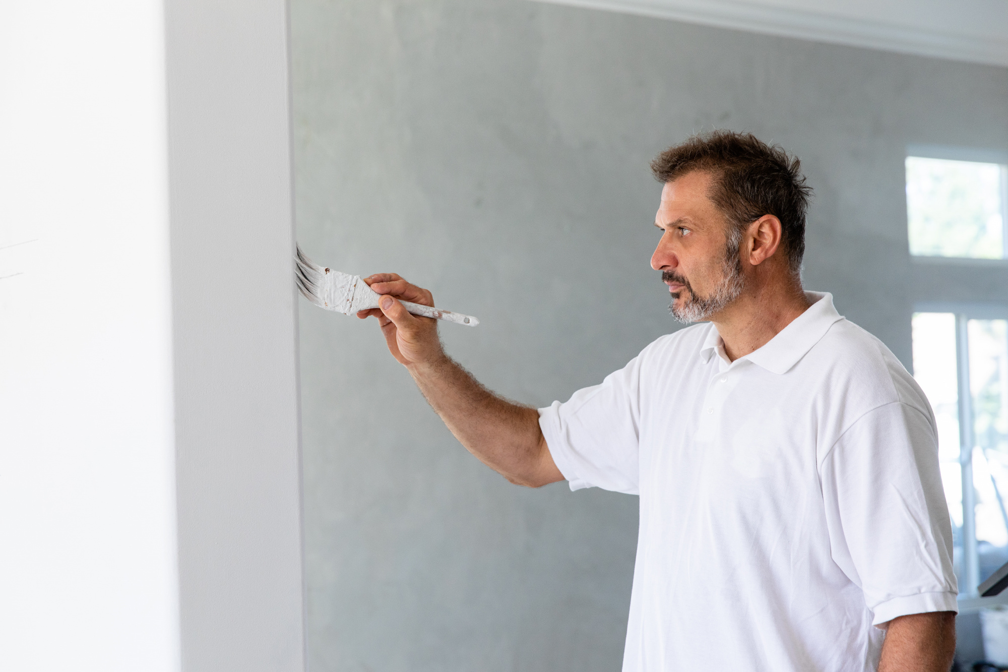 General contractor painting a wall during a home remodel
