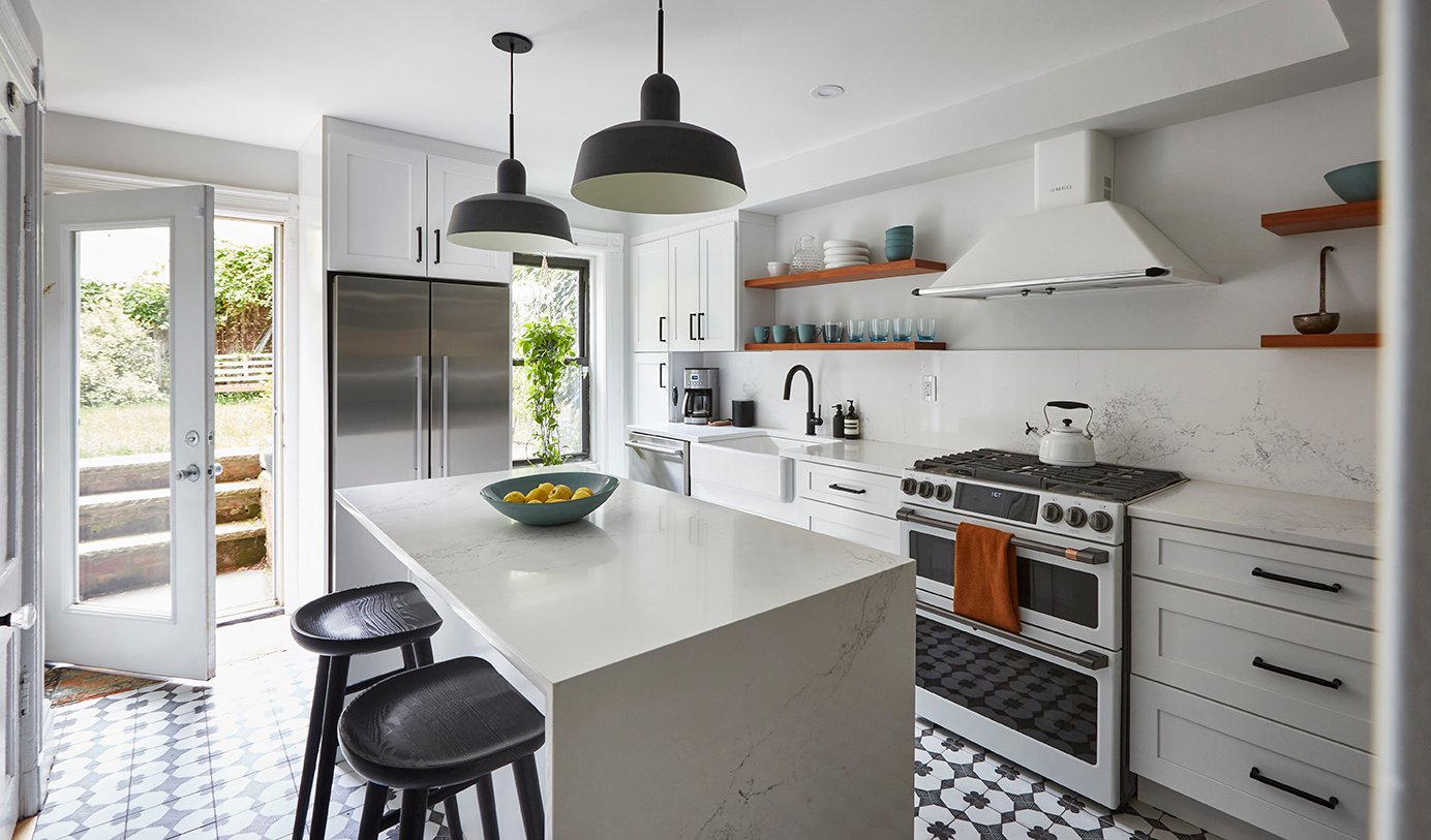 Brooklyn kitchen with patterned floor tiles, white cabinets and countertops, and matte black accessories and fixtures