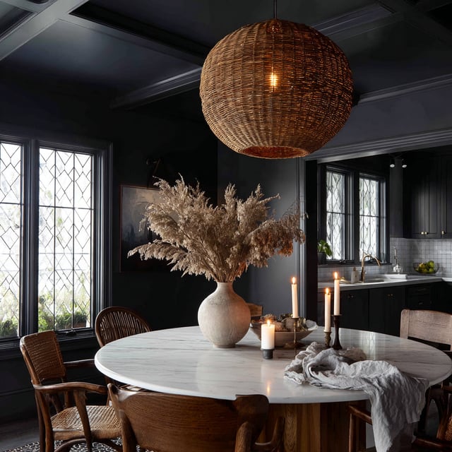 Moody dining room with black walls and a marble table.