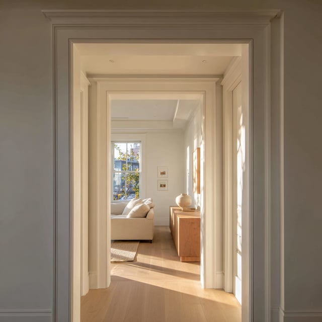  Elegant white doorways leading to a bright, modern room.