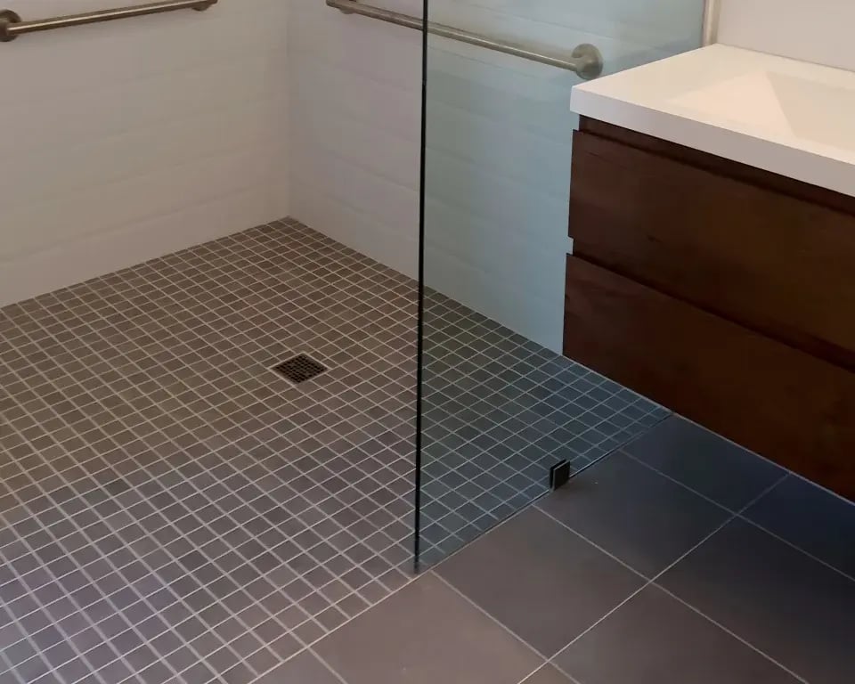 ADA-compliant bathroom with zero-threshold shower and grab bars.