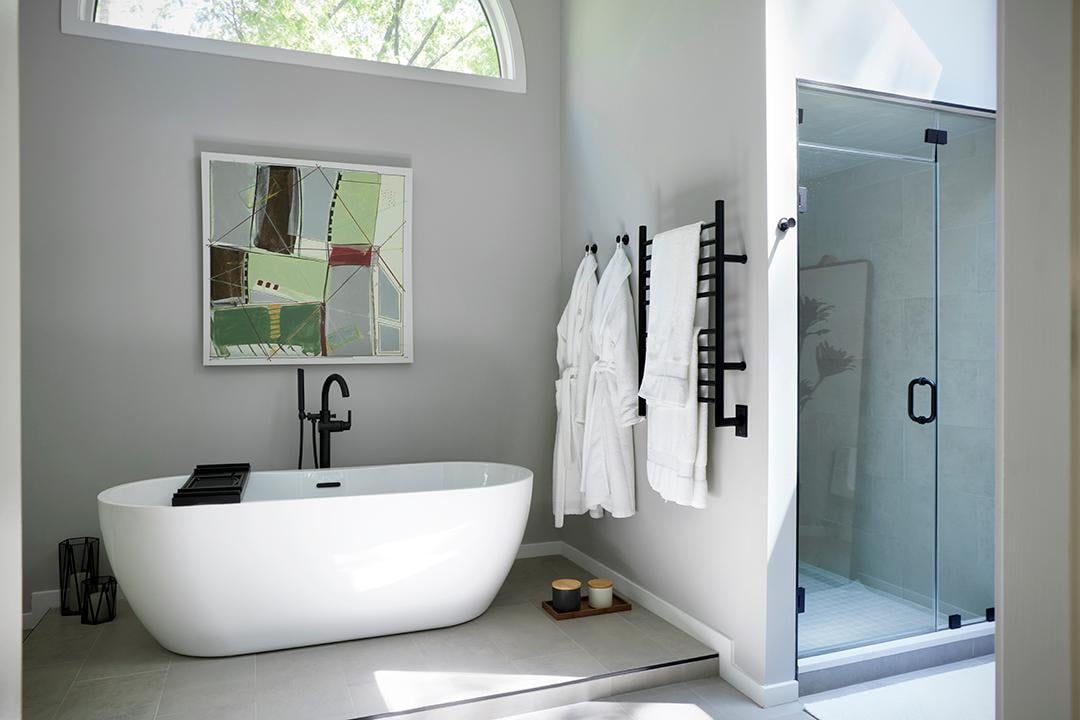 Modern bathroom with freestanding tub and glass shower.