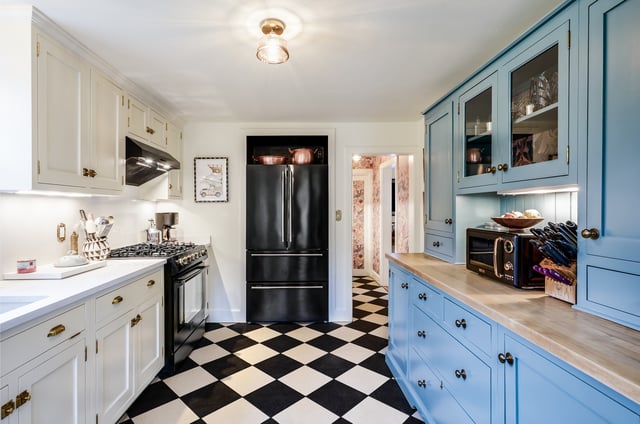 A bright kitchen with checkered flooring