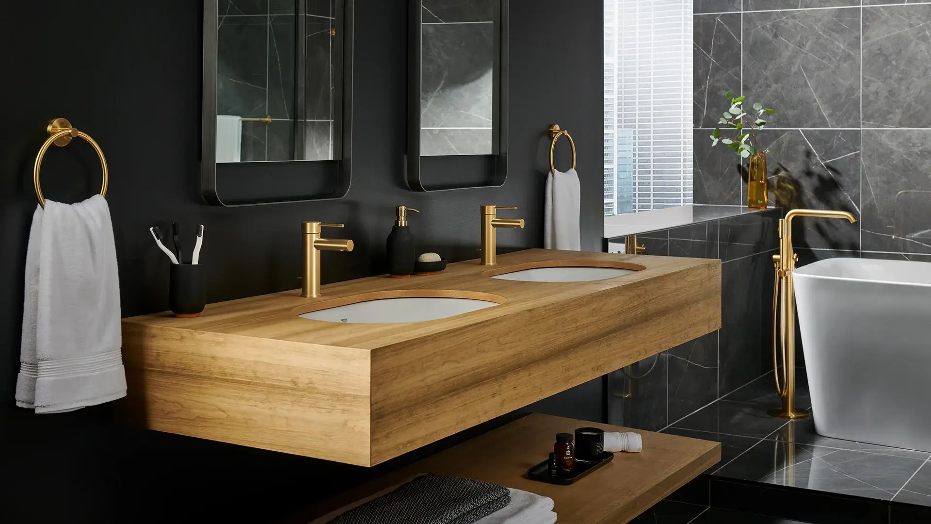 Floating double vanity with gold fixtures in a modern bathroom.