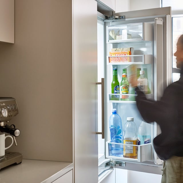 A remodeled modern New York kitchen featuring a hidden fridge with french doors