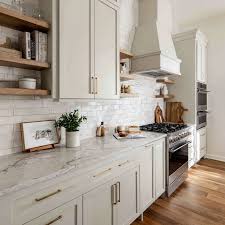 Kitchen island makeover showing yellow cabinets and marble.
