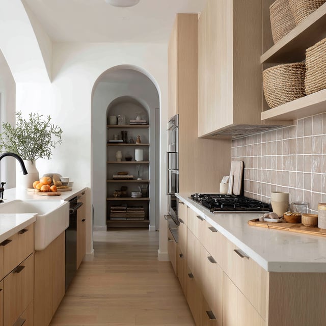 A bright Scandinavian-inspired kitchen with wood cabinets.