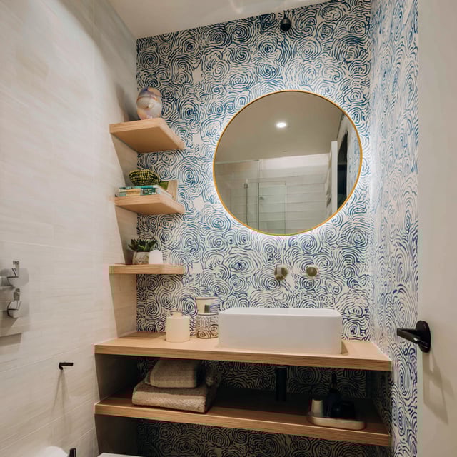 A stylish, compact bathroom that uses artistic patterns and natural textures to create a high-impact design.