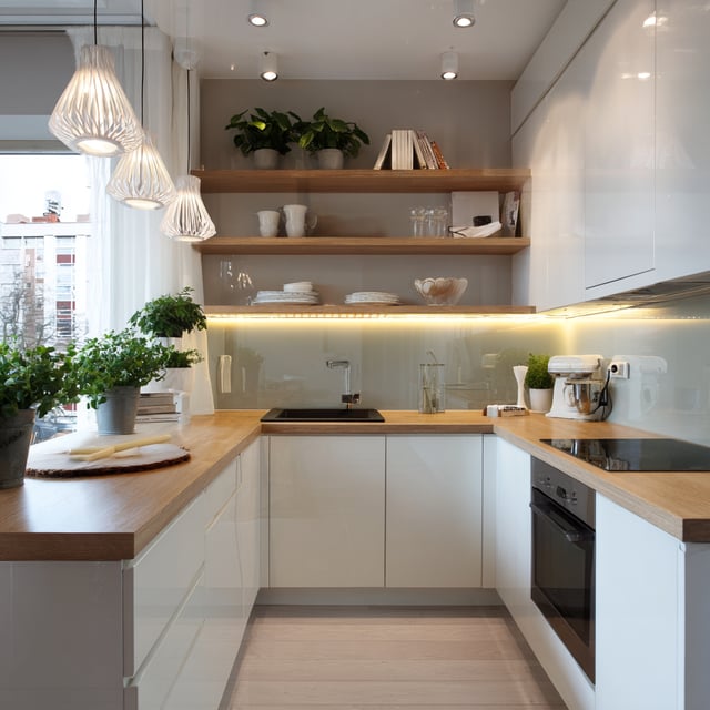 A modern, U-shaped compact kitchen that maximizes a small footprint with a clean, Scandinavian-inspired aesthetic.