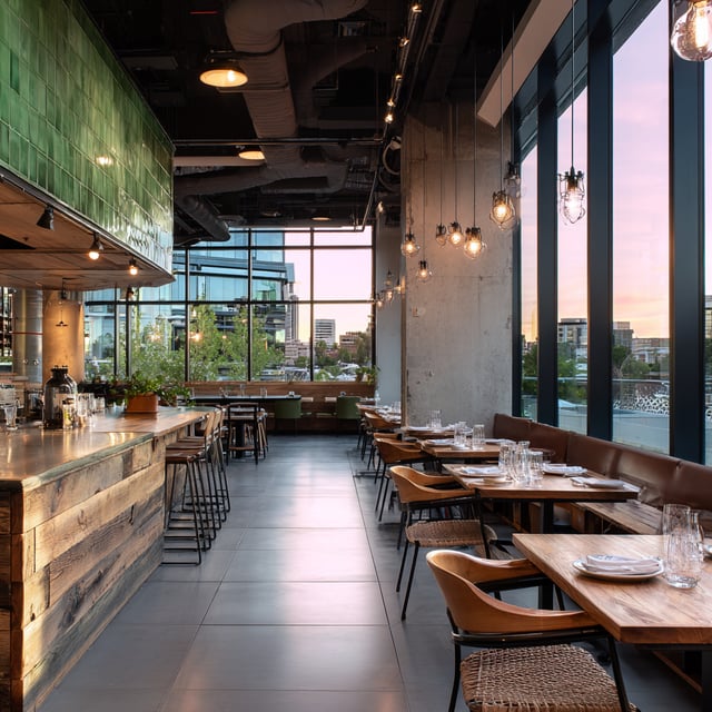 An industrial-chic restaurant featuring green-tiled accents, reclaimed wood bar, and floor-to-ceiling city views.