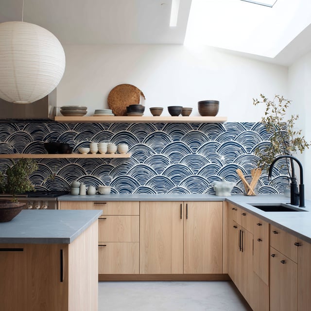  Modern kitchen with wood cabinets and blue wave backsplash.