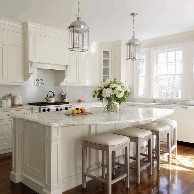  Cream Shaker kitchen with rounded marble island and stools.
