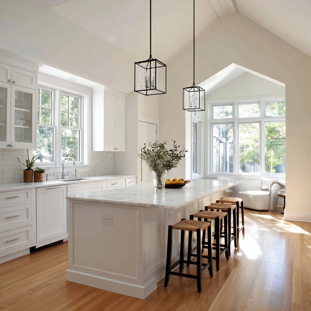A bright, airy kitchen characterized by a high cathedral ceiling and a clean, 