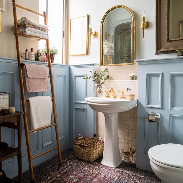 A brightly lit, eclectic bathroom featuring a mix of vintage and modern elements.