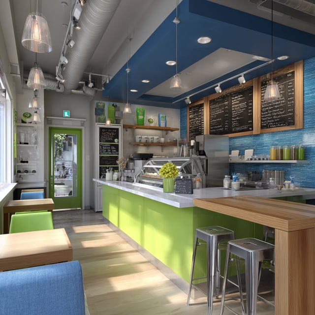 Bright modern café with green counter and chalkboard menu.