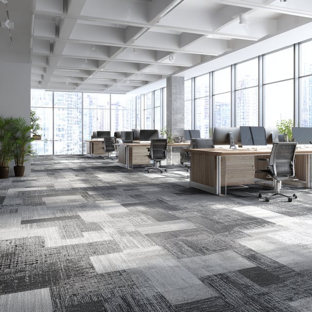 Modern open office with gray carpet and city views.