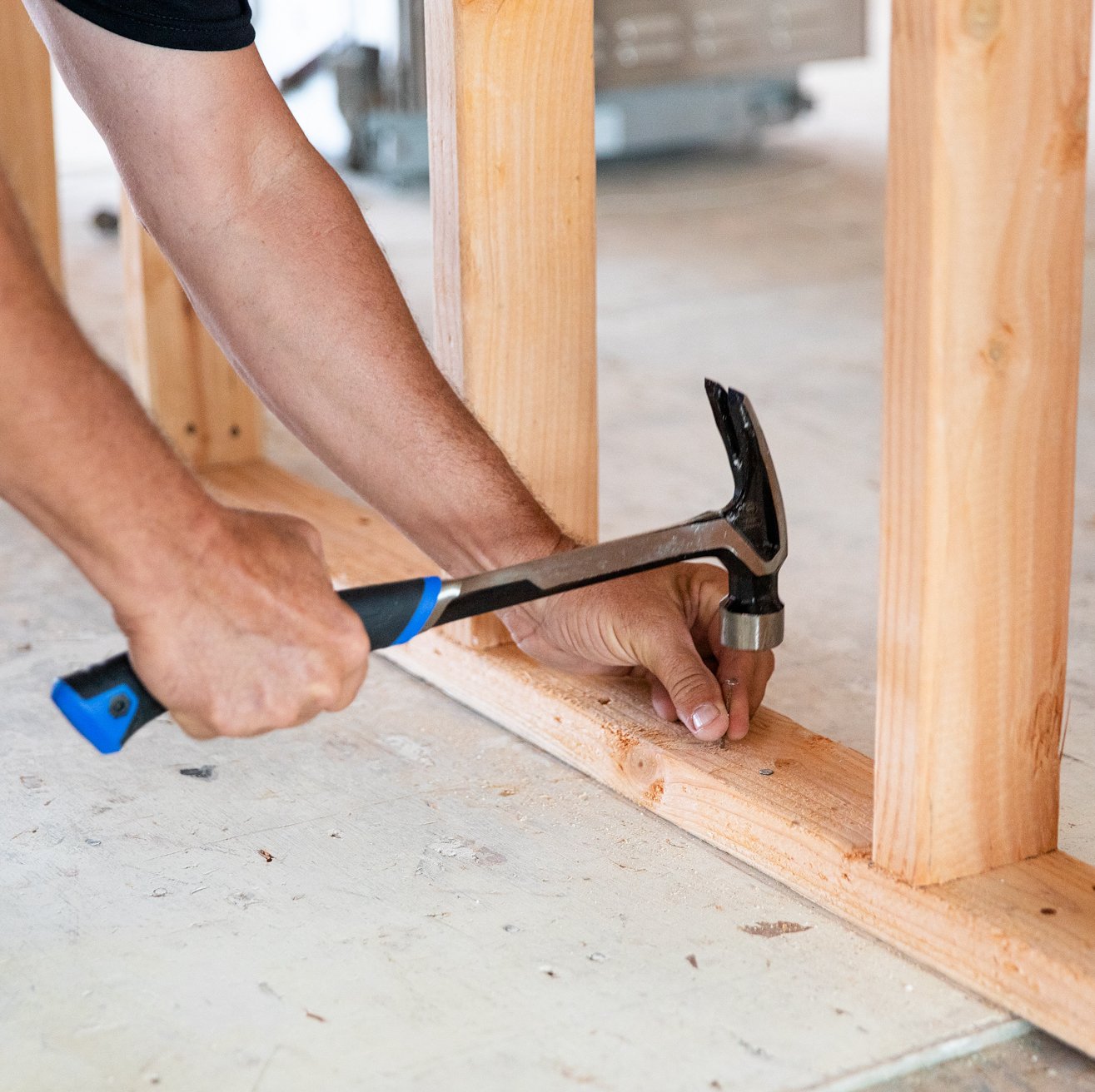 General contractor hammering a nail during a home renovation